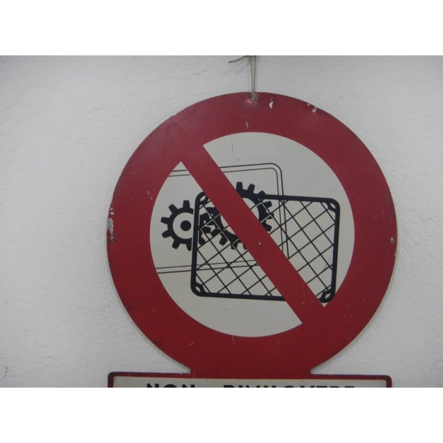 Safety sign indicating the obligation not to remove safety guards from machinery in the workplace. This piece has an...