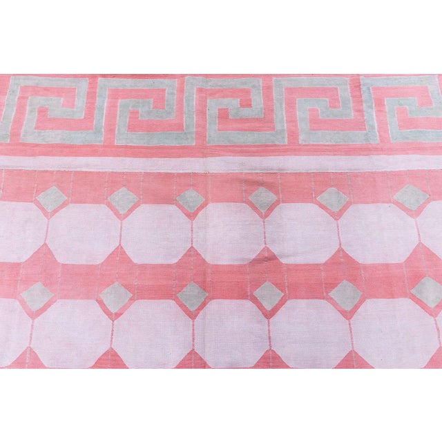 This striking vintage Indian Dhurrie rug, woven circa 1950, exemplifies the bold geometry and refined craftsmanship...