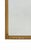 A refined late 18th to early 19th century neoclassical mirror featuring an elegant parcel-gilt frame with striking applied...