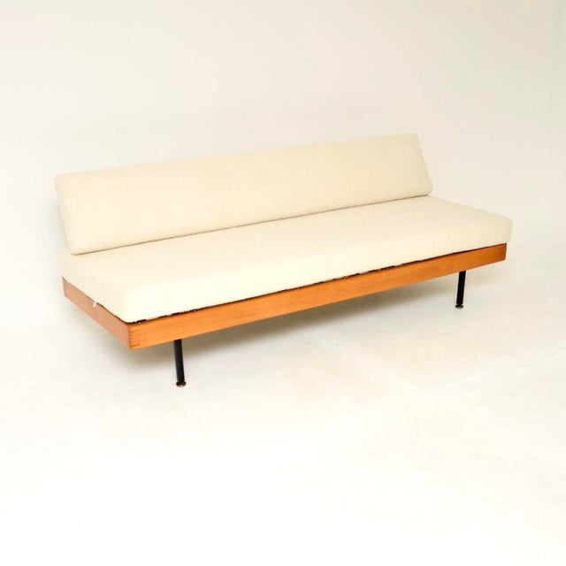 A stylish and extremely well made vintage sofa bed in steel and birch. This was made in England, it dates from around the...