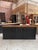 This antique shop counter has been fully restored. It features a beautiful walnut top and a black patinated cabinet body....
