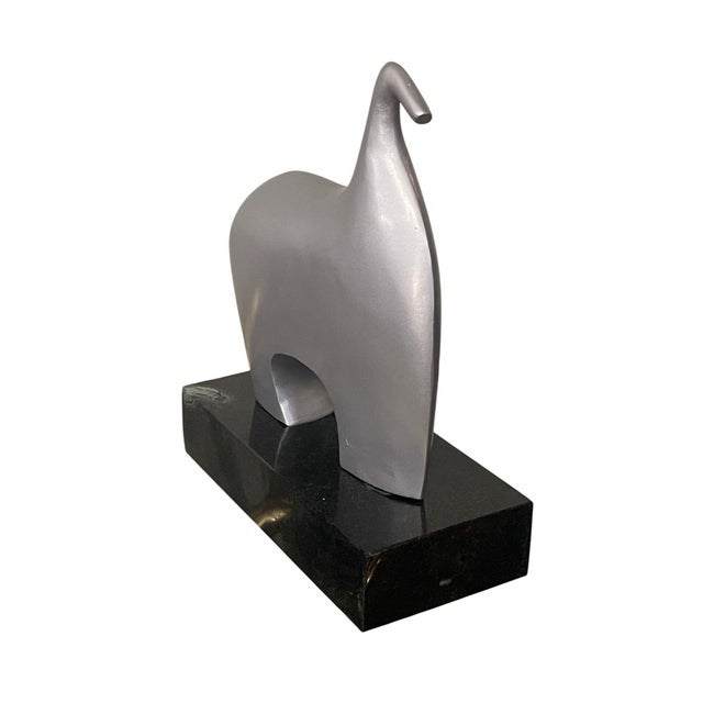A refined late 20th century American abstract animal sculpture by James Vilona, executed in a smooth, minimalist form that...