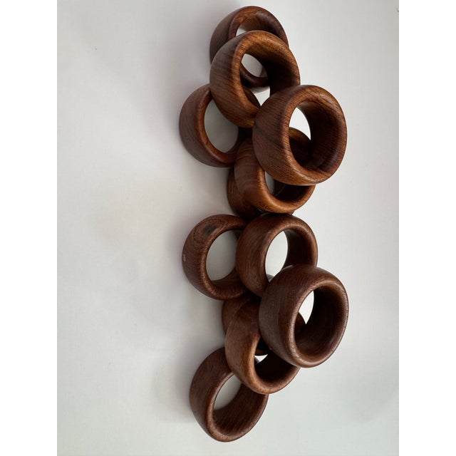 Beautiful set of 12 vintage solid wood napkin rings with substantial rounded forms and richly varied natural wood grain....