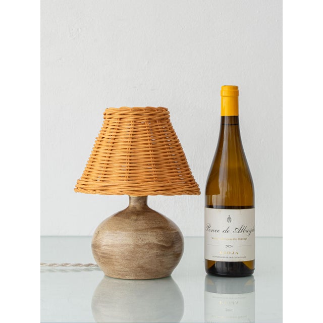 A small french studio table lamp on a hand-thrown grès base, the dense, high-fired stoneware independent french potters...