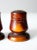 This is a pair of vintage salt & pepper shakers dated 1935. In hand-written yellow paint, the wooden shakers read "From...