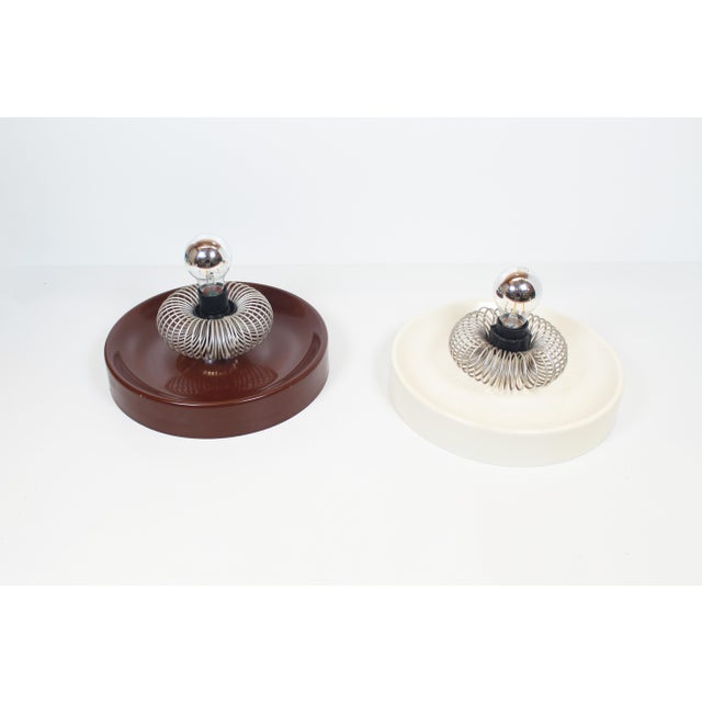A unique and uncommon set of wall lamps by the hungarian manufacturer elektrofém. These lacquered metal "discus" wall...
