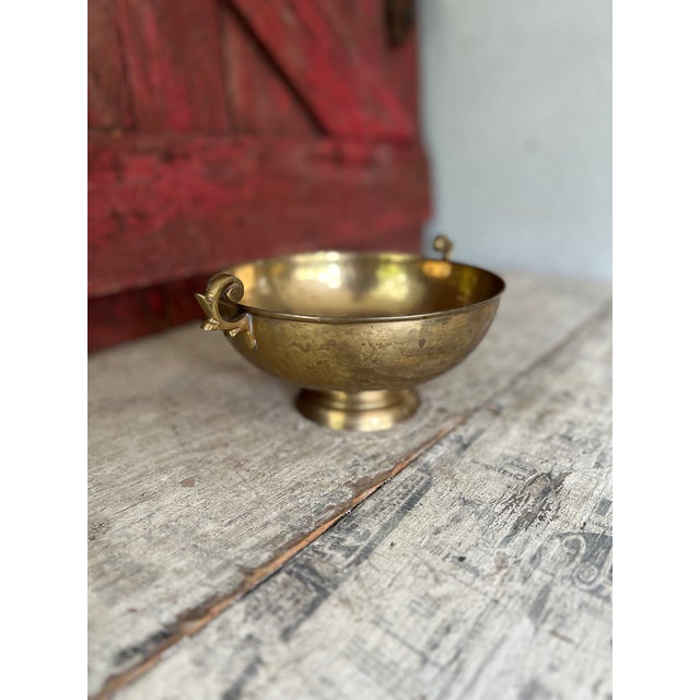 This vintage footed compote bowl crafted from hammered brass showcases ornate handles and a warm patina. A timeless accent...