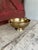 This vintage footed compote bowl crafted from hammered brass showcases ornate handles and a warm patina. A timeless accent...
