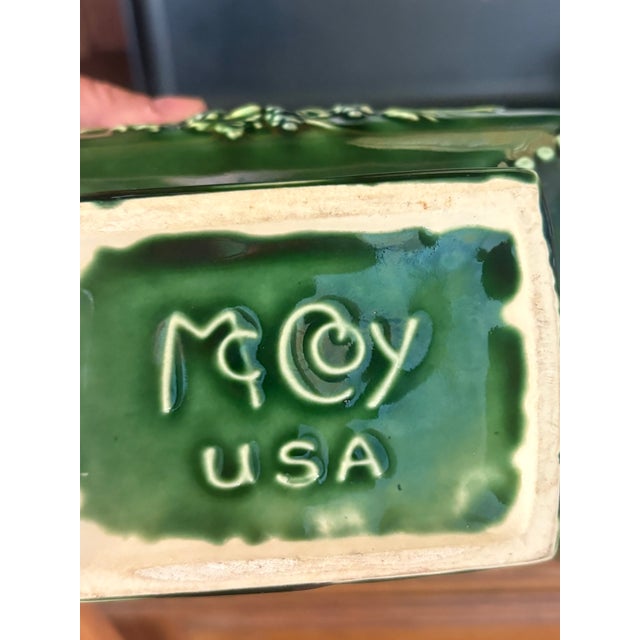 Mid-century McCoy Pottery planter in green glaze, rectangular form with canted corners on a ribbed pedestal foot. Embossed...
