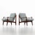 Pair of lounge chairs on a smooth wooden frame with elegantly curved armrests and slatted backrests. The armchairs are...