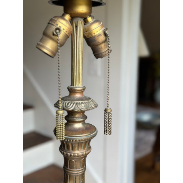 An early-20th-century reverse-painted art glass table lamp attributed to the Pittsburgh Lamp, Brass & Glass Company...