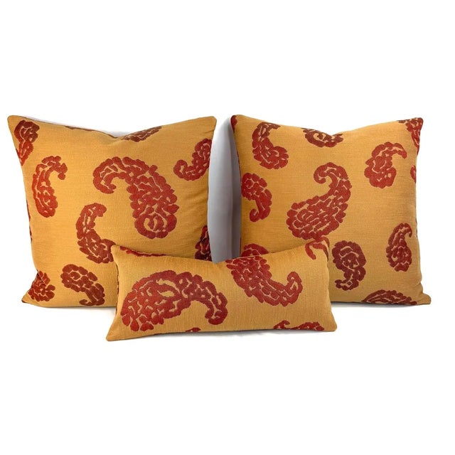 From Scalamandre is Katmandu in Gold and Red pillow cover. This pillow features red paisley designs on a dark gold...