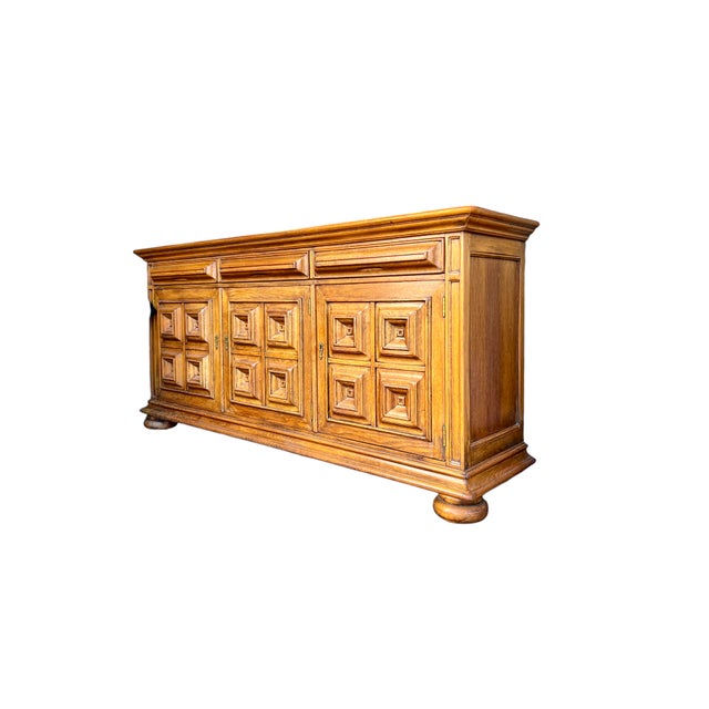 A brutalist sideboard made of solid oak, in the Spanish colonial style, dating from the 1960s. The sideboard stands out...