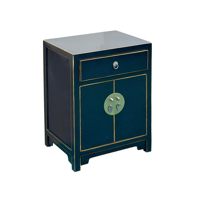 This elegant accent cabinet features a rich black finish accented with fine golden lining along its edges, beautifully...