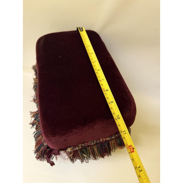 Introduce a touch of unique, old-world elegance to your space with this charming vintage upholstered footstool. This...