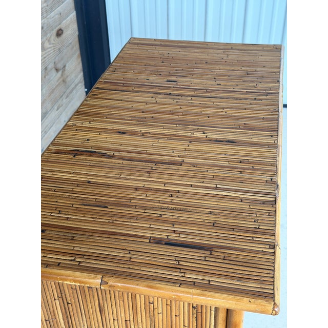 A beautifully refinished split rattan chest of drawers by Milling Road, a division of Baker Furniture. This piece...