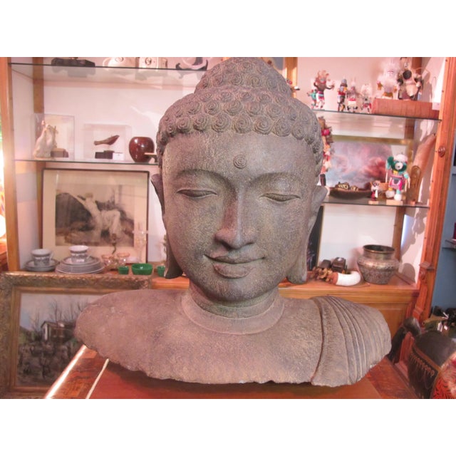 Captivating, late 19th century, large Indonesian stone carving of Buddha on wood stand. This is an unusually fine...