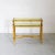 This vintage double-tiered console table perfectly embodies Midcentury Modern style with Hollywood Regency influences. The...