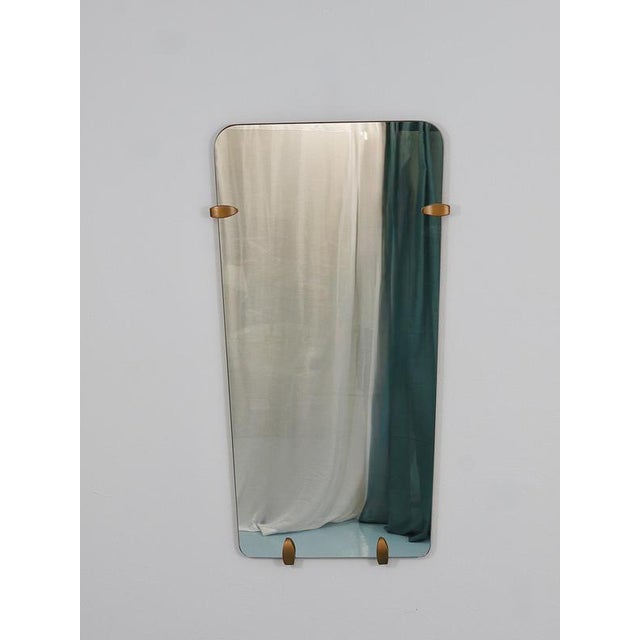 A charming frameless Mid-Century Modern wall mirror from the 1950s, handcrafted in Vienna, Austria. The mirror stands out...