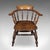 This is an antique smoker's bow chair. An English, elm and beech country house elbow seat, dating to the Edwardian period,...