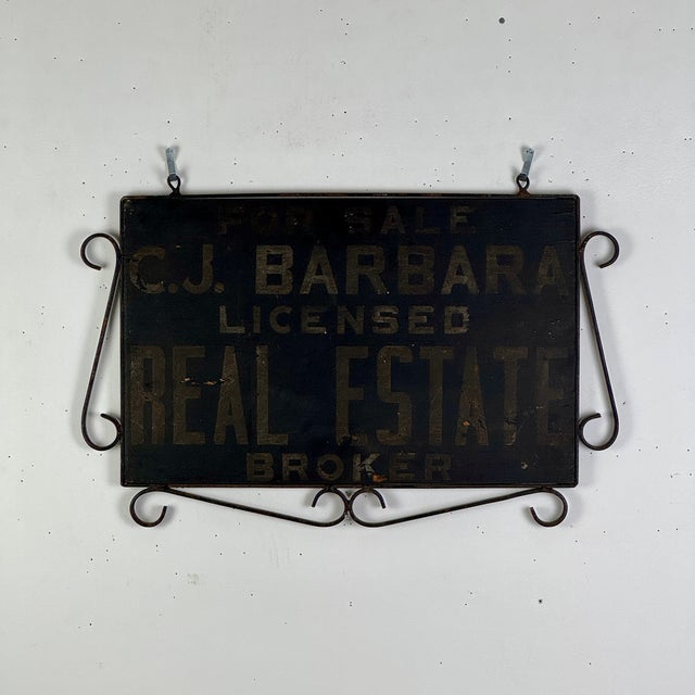 An ornate antique double sided hand painted trade sign advertising C.J. Barbara Licensed Real State Broker. The middle...