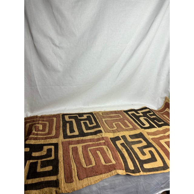This gorgeous African Kuba cloth features ornate geometric details woven in raffia, a natural palm fiber. The...