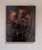 The artwork depicts a figure partially obscured by shadows, with a delicate interplay of light highlighting their features...