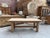 This 1960s oak farmhouse table has been fully restored. It features a thick tabletop and a sturdy base with a crossbar....