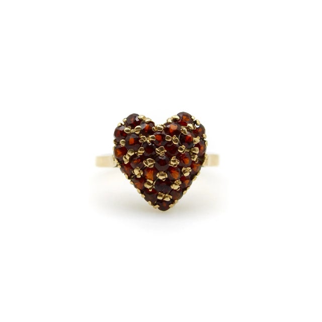 This 18k gold pave garnet ring is encrusted with 2 mm round garnets to create a beautiful sparkle of gold and wine-colored...