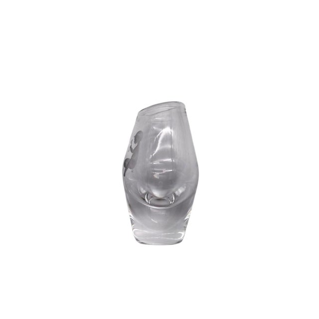This vase is blown in heavy clear glass and is teardrop shaped. One side is sandblasted with an image of a young child...