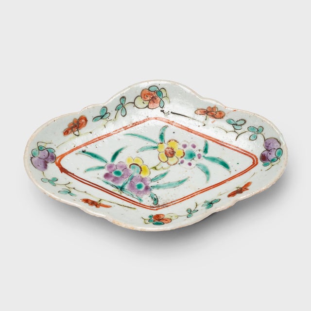 This charming porcelain dish dates to the early 20th century and is decorated with colorful overglaze enamels in the...