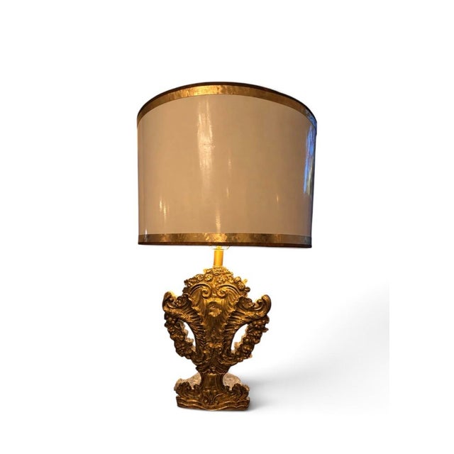 A striking one-of-a-kind table lamp custom-created from an intricately carved giltwood architectural fragment. The...