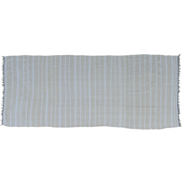 Vintage throw handmade in the High Atlas Mountains of Morocco. Featuring ornate Berber stripes on a beige background....