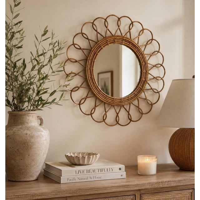 Beautiful vintage rattan sunburst wall mirror featuring an elegant looping sculptural frame and warm natural honey tones....
