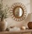 Beautiful vintage rattan sunburst wall mirror featuring an elegant looping sculptural frame and warm natural honey tones....