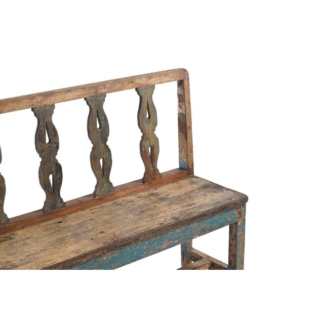 This Vintage Indian Painted Teakwood Bench is constructed from solid teakwood, featuring a decorative open-back design...