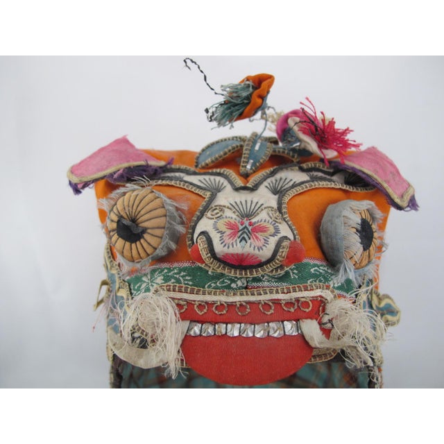Elaborate antique Chinese festival hat in the form of a tiger or dragon, likely dating from late 19th to early 20th...