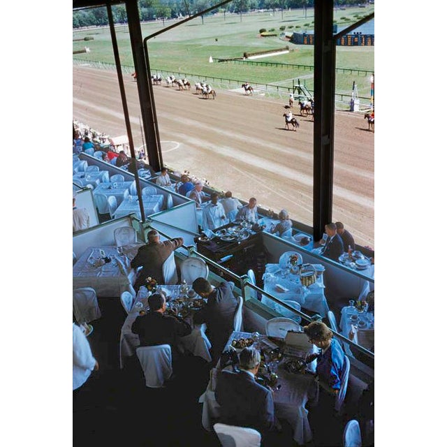 Racegoers At Saratago by Toni Frissell Race goers enjoy a meal at the Saratoga race course, USA, 1960. (Photo by Toni...