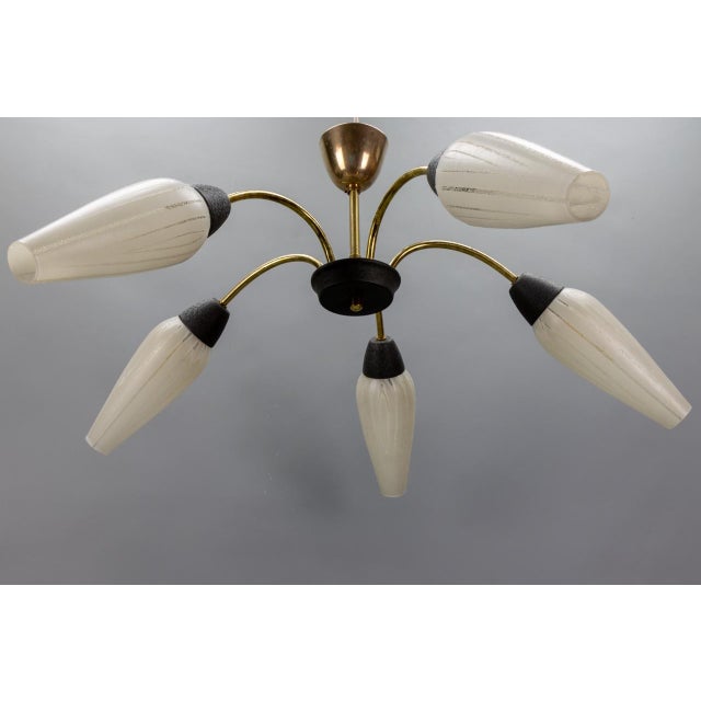 Mid-Century Modern Five-Light Sputnik Chandelier in Brass and White Glass, Germany, 1950s This elegant mid-century...