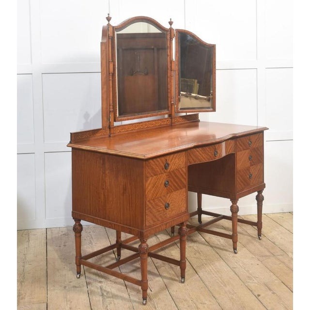 A fine early 20th-century satinwood dressing table, distinguished by its warm tone and beautifully figured veneers...