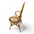 20th Century fan-back barrel rattan bamboo arm chair. Crafted from natural woven wicker and rattan, the piece features an...