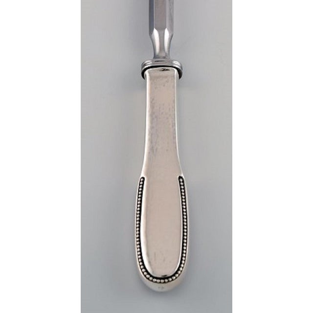 Rare Evald Nielsen number 14 sharpening steel in hammered silver and stainless steel. 1920s. Length: 30.8 cm. Stamped. In...