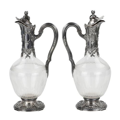 Pair of French glass wine jugs in silver. with the motif of sprouting shoots along the graceful handles and necks of the...