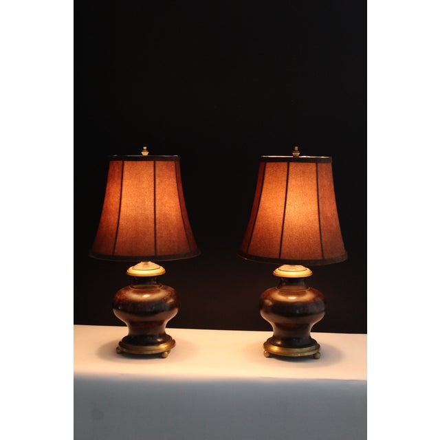 A pair of Empire style early 20th century burnished bronze and antique brass .Beautiful finish embellished by the brass...