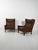 Pair of armchairs, likely Danish, from the 1950s, in dark brown leather, with high backs and removable cushion covers....