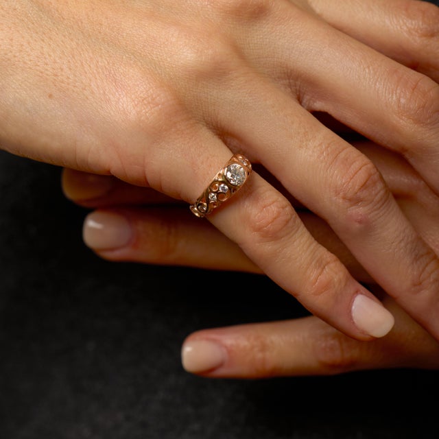 This vintage engagement ring embodies warmth, balance, and timeless romance through its graceful design and softly glowing...