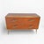 An elegant chest of drawers featuring surfaces entirely clad in amber-toned mirror, creating a sophisticated interplay of...