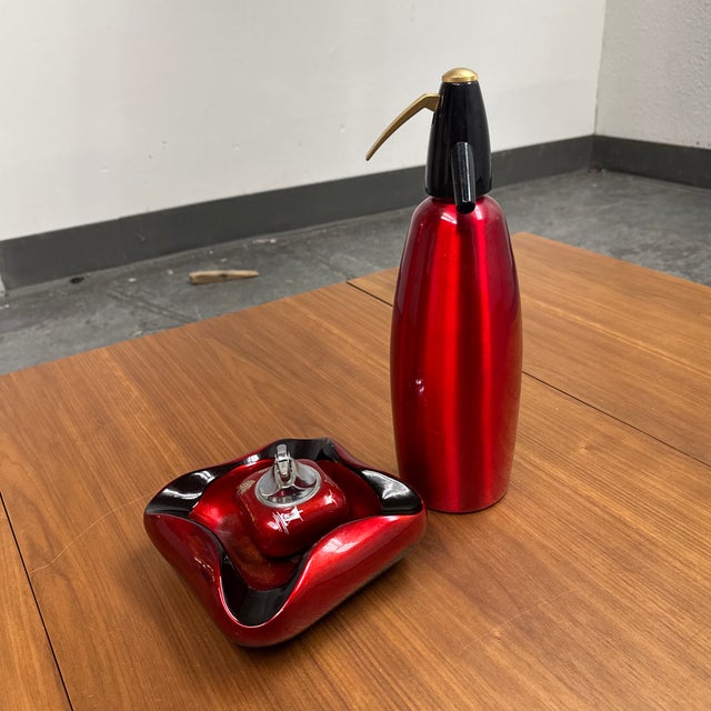 Design Plus Gallery presents the Red Soda Siphon, Ashtray + Table Lighter Set from iSi Austria. Dating to 1984, the...
