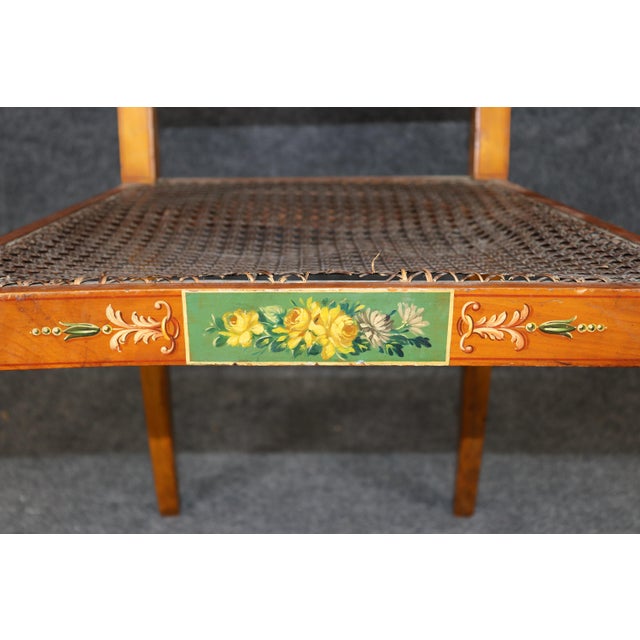 This elegant pair of Adams-style painted and caned side chairs, dating from the late 19th century to the early 20th...