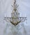 This grand eight‑arm chandelier features an ornate brass or bronze frame with beautifully curved arms and intricate...
